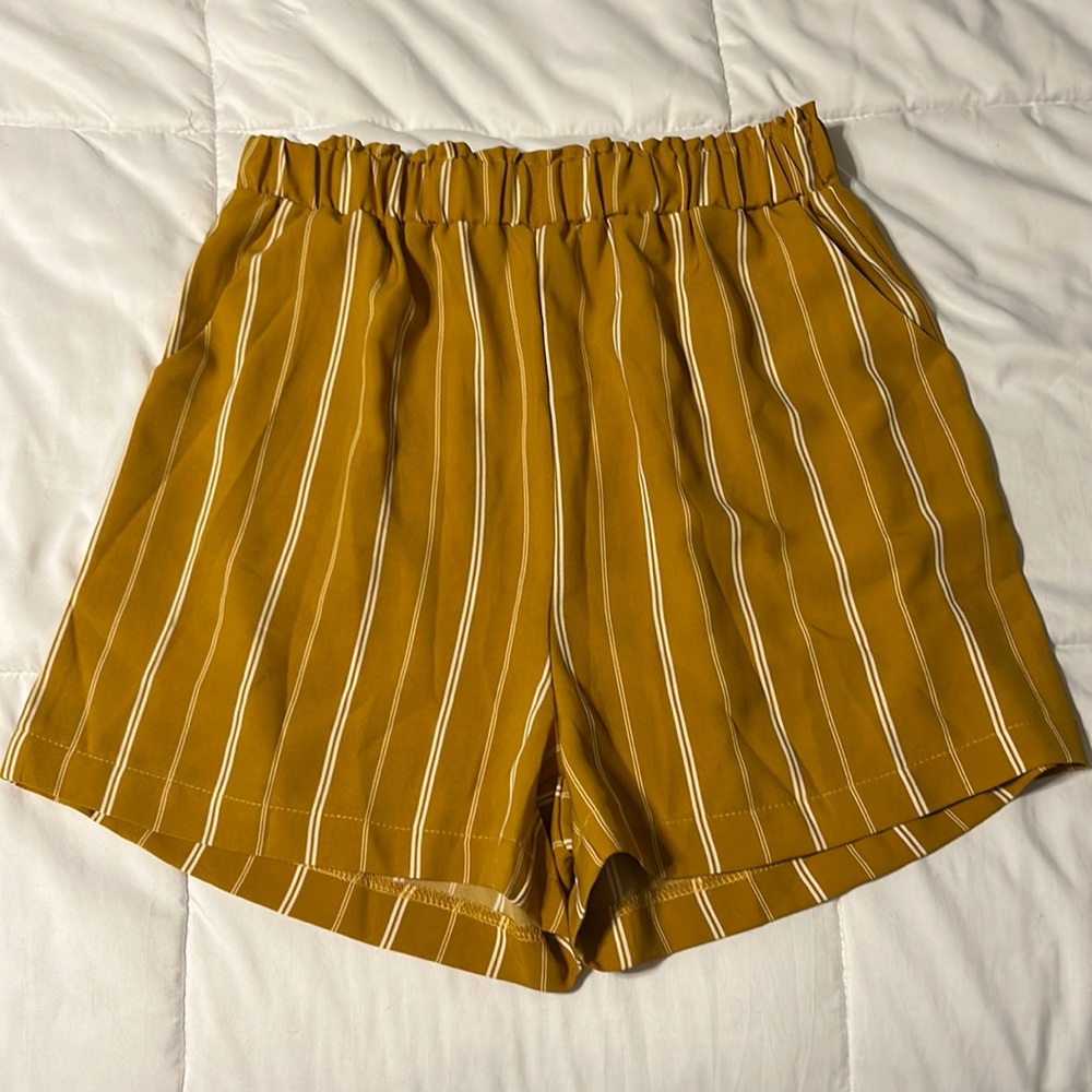 High waisted mustard shorts with white stripes, elastic waistband and pockets!